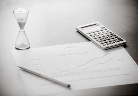 hour glass calculator and chart on a grey table
